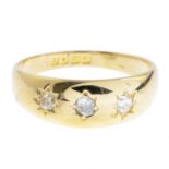 A diamond three-stone ring, with 18ct gold band replacement.Estimated total diamond weight 0.25ct.