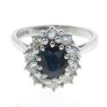 An 18ct gold sapphire and diamond cluster ring.Estimated total diamond weight 0.40ct,