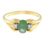 A diamond and green gem three-stone ring.Stamped 750.