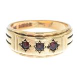 A gentleman's 9ct gold garnet three-stone ring.Hallmarks for Birmingham, 1968.Ring size U1/2.