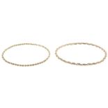 Two 9ct gold bangles.Hallmarks for London, 1979 and 1984.Inner diameters 6.6 and 7cms.