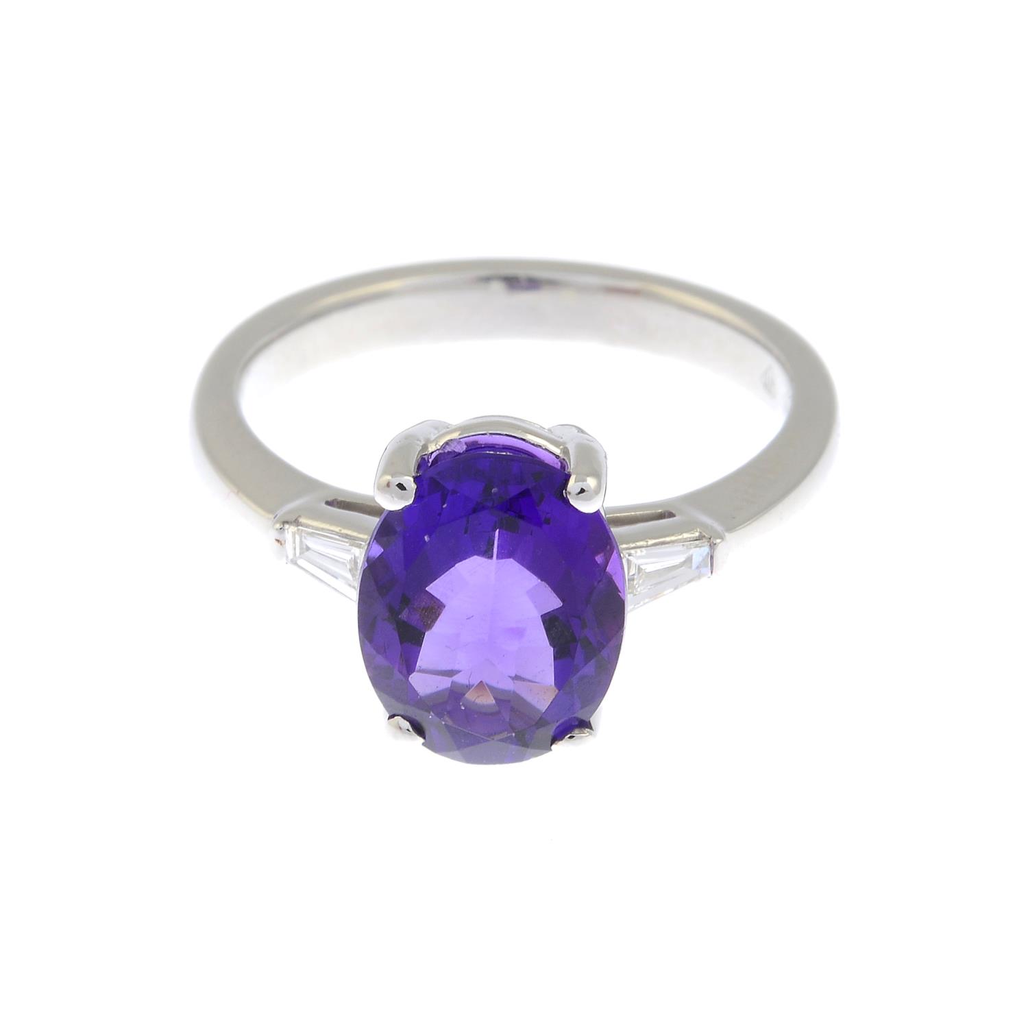 An amethyst and diamond three-stone ring.Estimated total diamond weight 0.10ct.