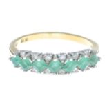 An 18ct gold emerald and diamond ring.Estimated total diamond weight 0.25ct.