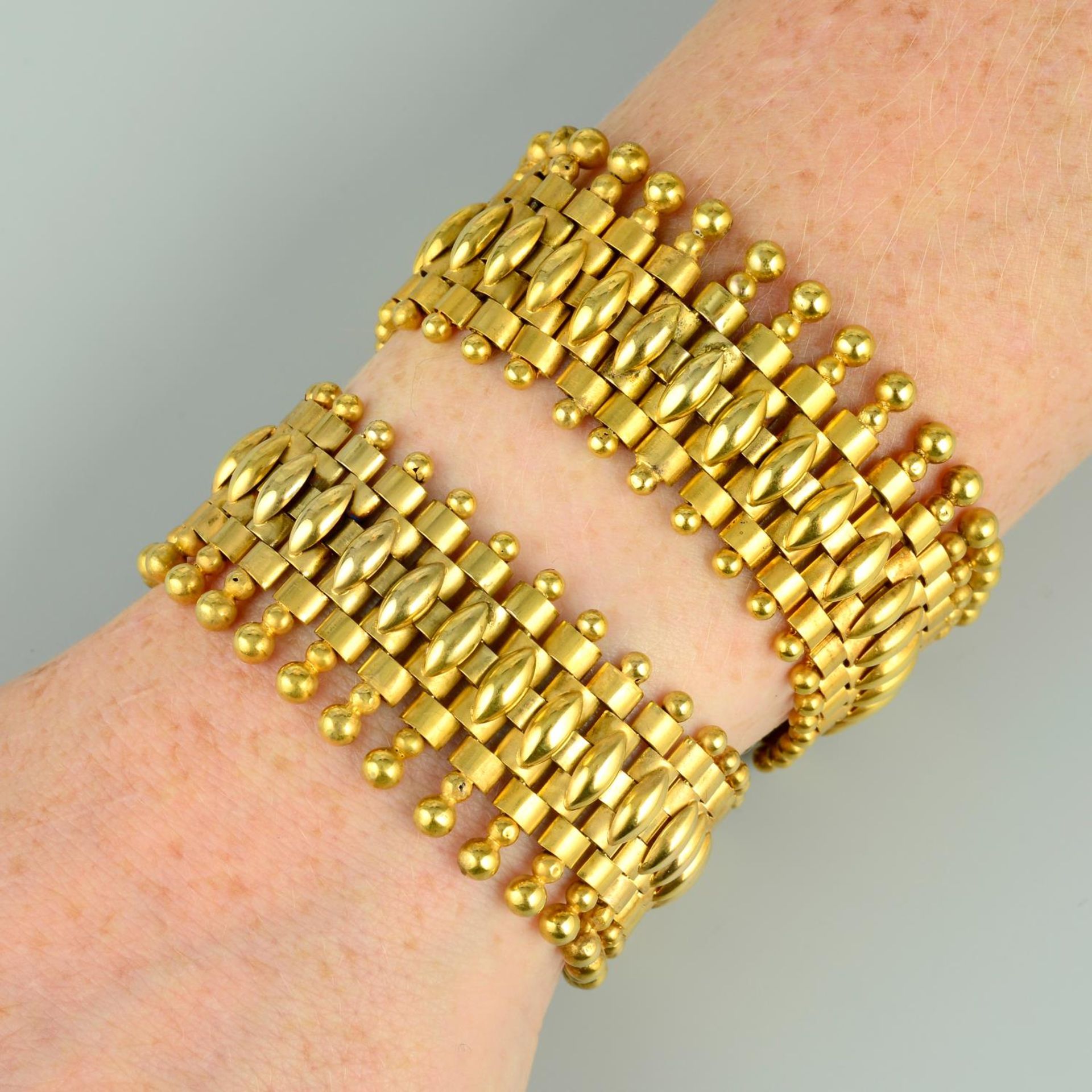 A pair of late 19th century gold bracelets.Length 19.5cms each.