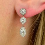 A pair of marquise-shape and brilliant-cut diamond cluster drop earrings.Estimated total diamond