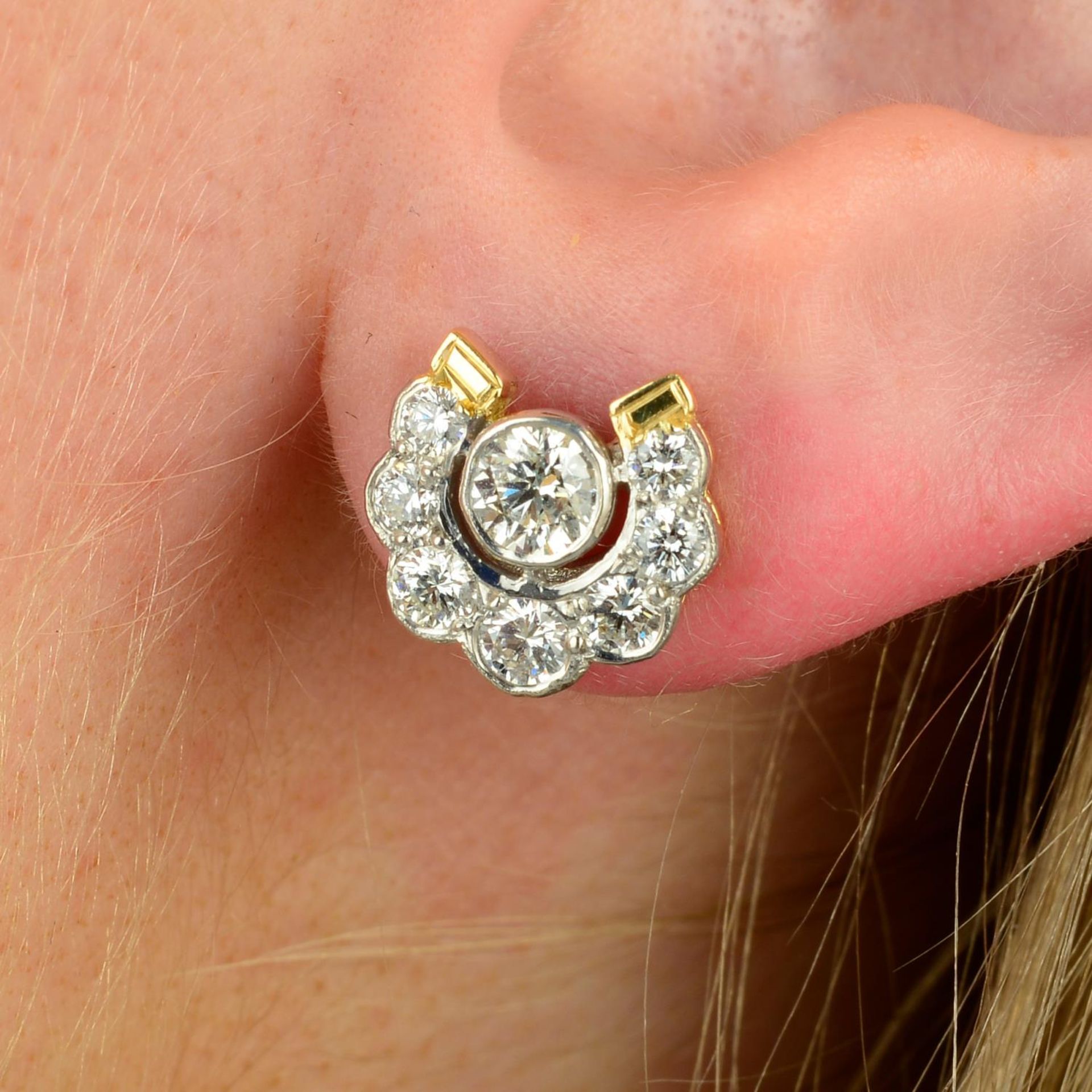A pair of brilliant-cut diamond horseshoe earrings.Estimated total diamond weight 1.20cts,