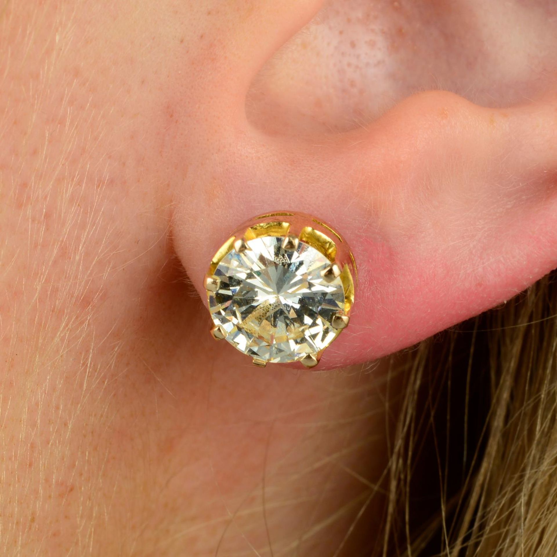 A pair of brilliant-cut diamond stud earrings.