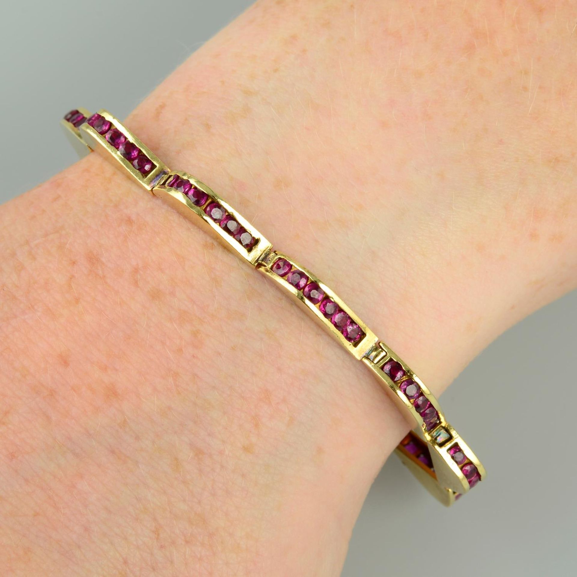 A ruby bracelet, of undulating wave form.