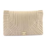 CHANEL - an oversized nude leather Coco Pleats clutch.