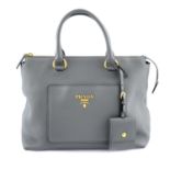 PRADA - a front pocket handbag.