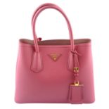 PRADA - a pink Saffiano handbag.