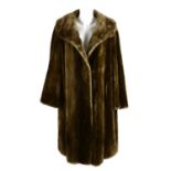 A knee-length sheared beaver coat.