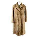 A knee-length pastel mink coat.