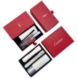 CARTIER - a group of boxed cleaning kits.