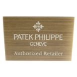 PATEK PHILIPPE - a brass 'Authorized Retailer' display sign.