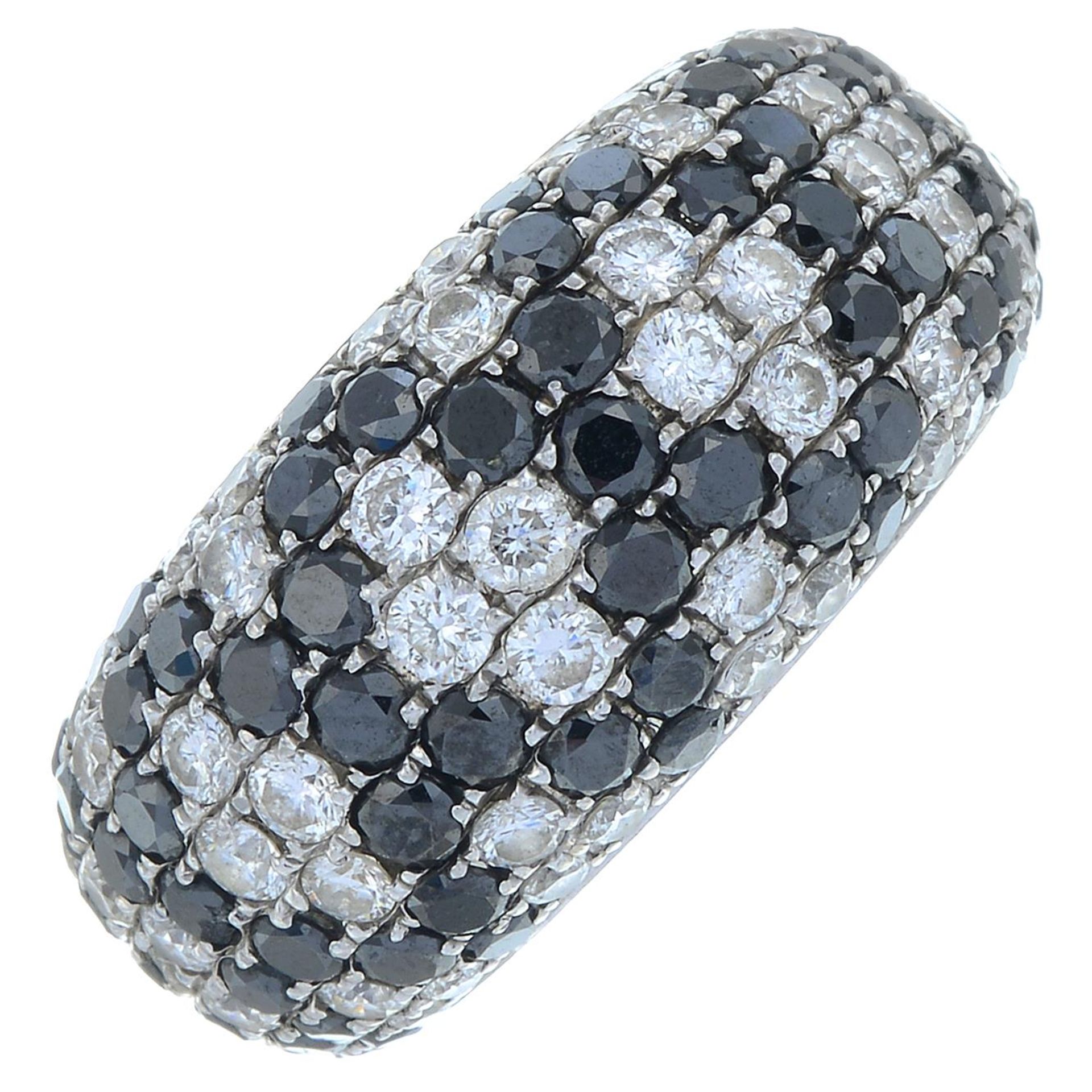 An 18ct gold brilliant-cut diamond and black gem dress ring.