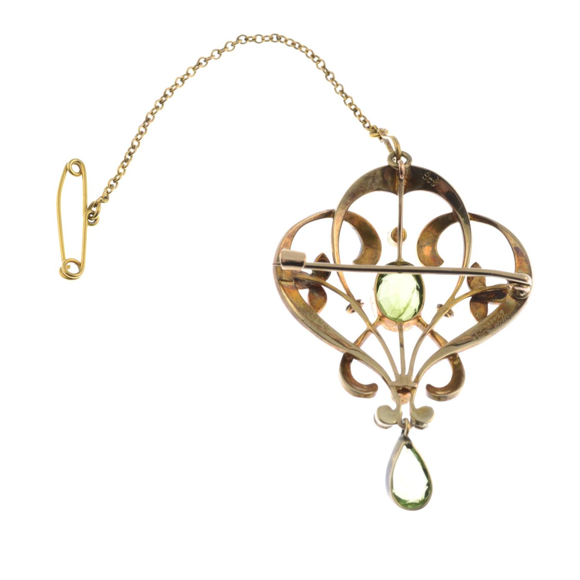 An early 20th century 9ct gold peridot and split pearl openwork floral brooch.May also be worn as a - Image 2 of 2