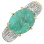An 18ct gold emerald and brilliant-cut diamond dress ring.Emerald calculated weight 3.80cts,