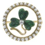 A split pearl and green enamel brooch.Diameter 2.2cms.