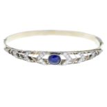 A sapphire and circular-cut diamond hinged bangle.Sapphire calculated weight 1.11cts,