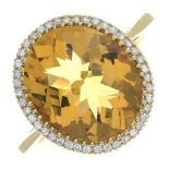 An 18ct gold citrine and brilliant-cut diamond cluster ring.Citrine calculated weight 4.21cts,