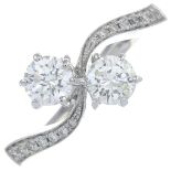 A brilliant-cut diamond two-stone crossover ring.Total diamond weight 1.32ct,