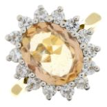 An 18ct gold brownish-yellow topaz and brilliant-cut diamond cluster ring.Topaz calculated weight