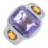 An amethyst and citrine three-stone ring.Amethyst calculated weight 4.66cts,