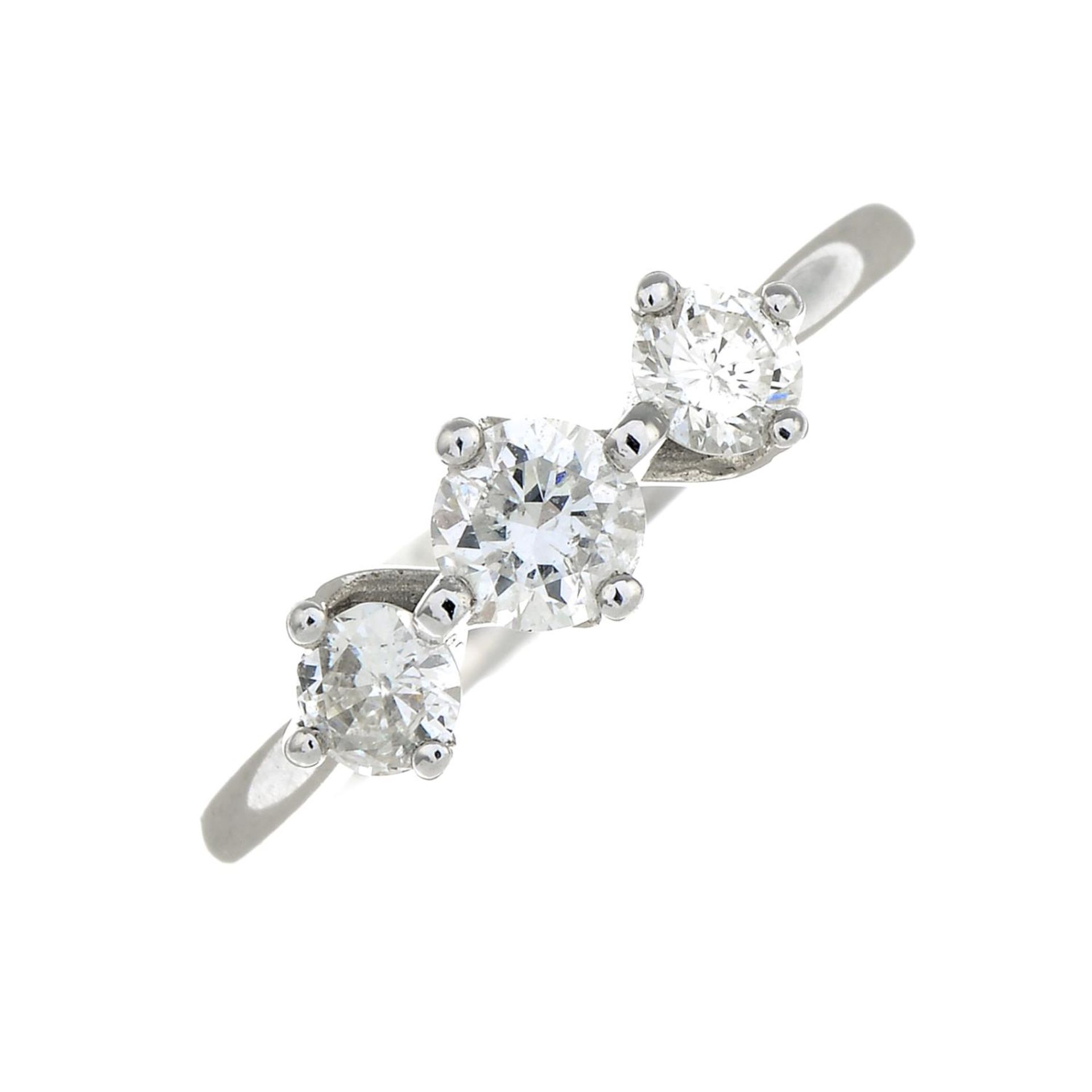 An 18ct gold brilliant-cut diamond three-stone ring.