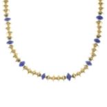 An 18ct gold necklace, with lapis lazuli highlights.Hallmarks for London.Length 42cms.