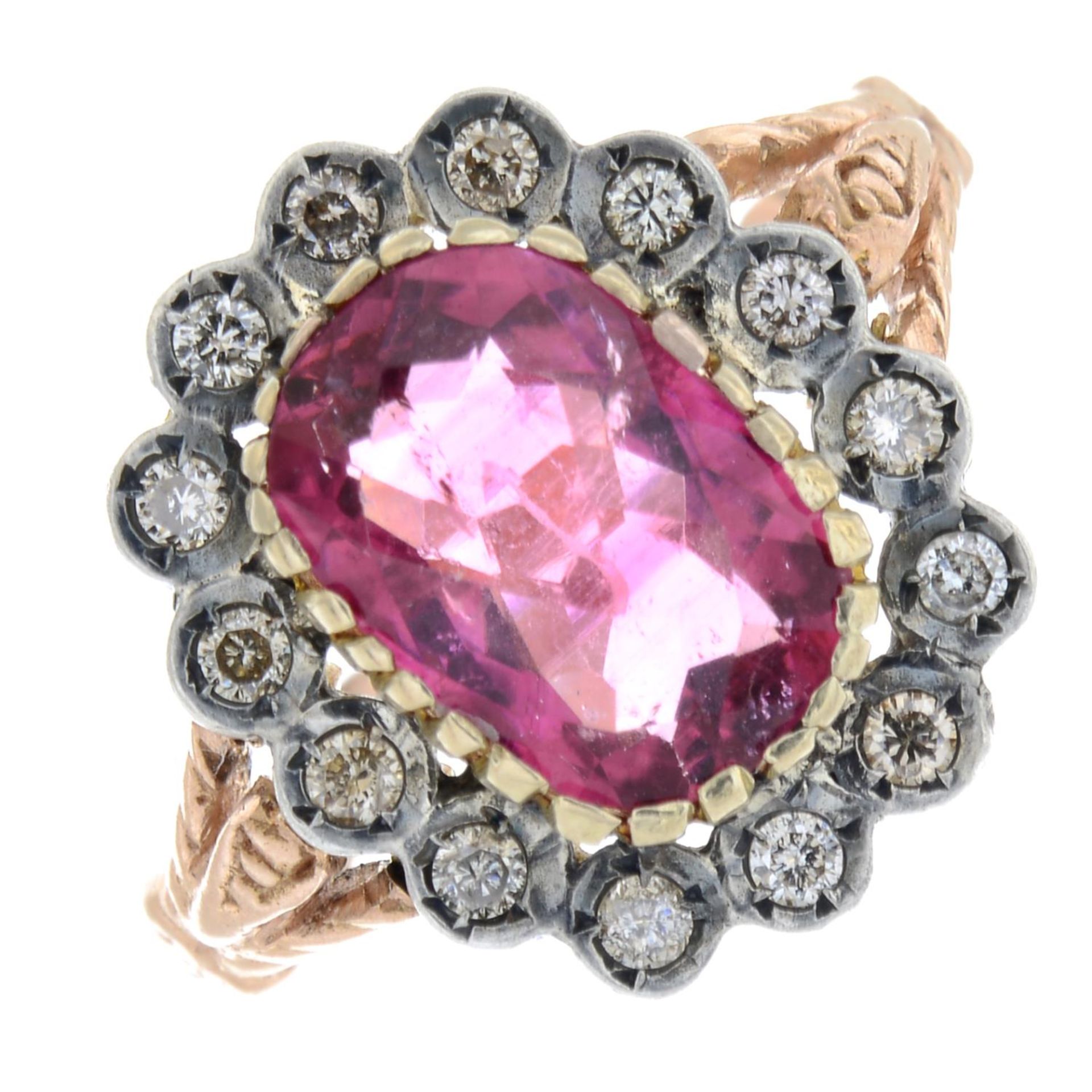 A pink tourmaline and brilliant-cut diamond cluster ring.Tourmaline weight 2.10cts.Estimated total