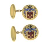 A pair of enamel cufflinks, depicting a coat of arms.