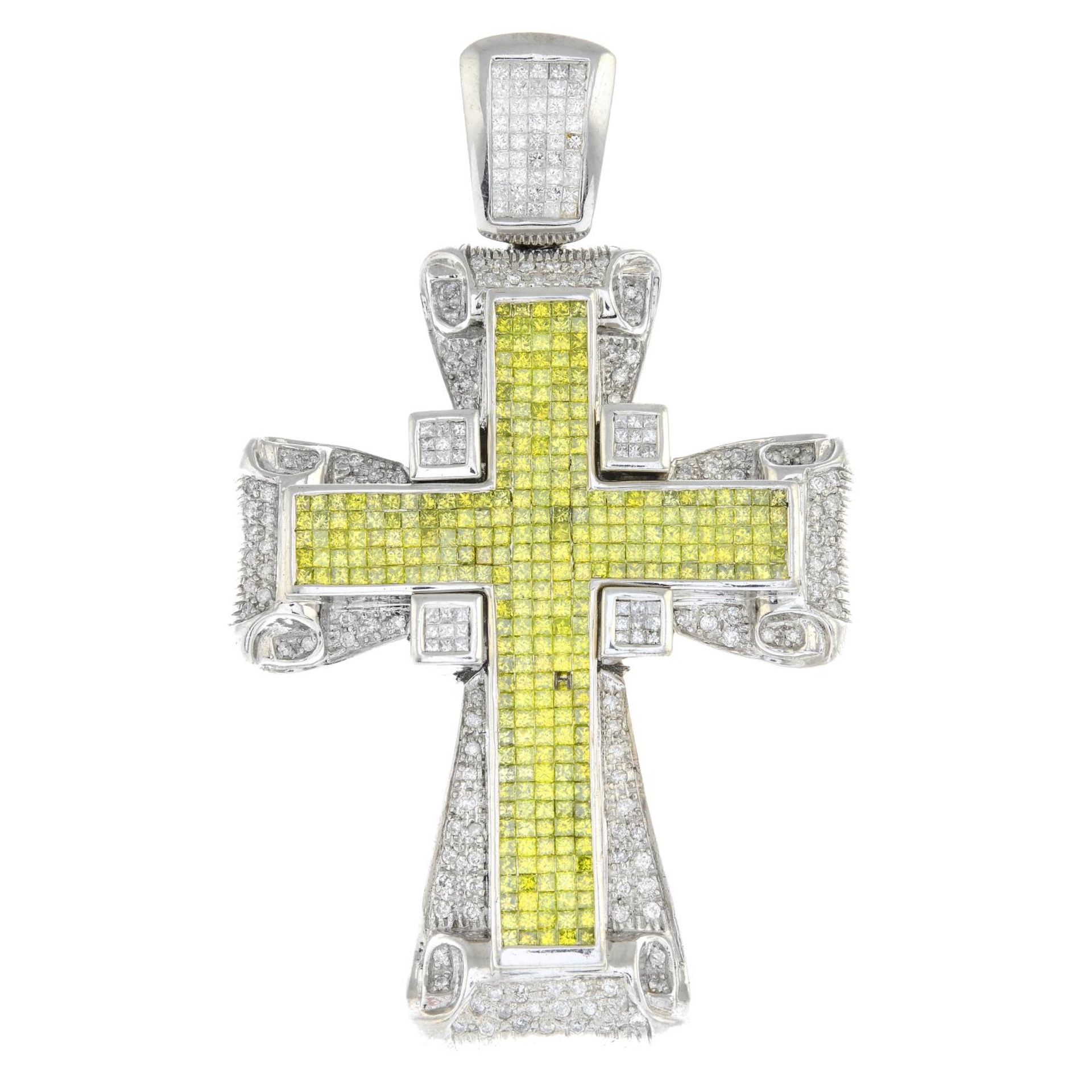 A vari-cut diamond and colour-treated yellow diamond cross pendant.One diamond deficient.Estimated