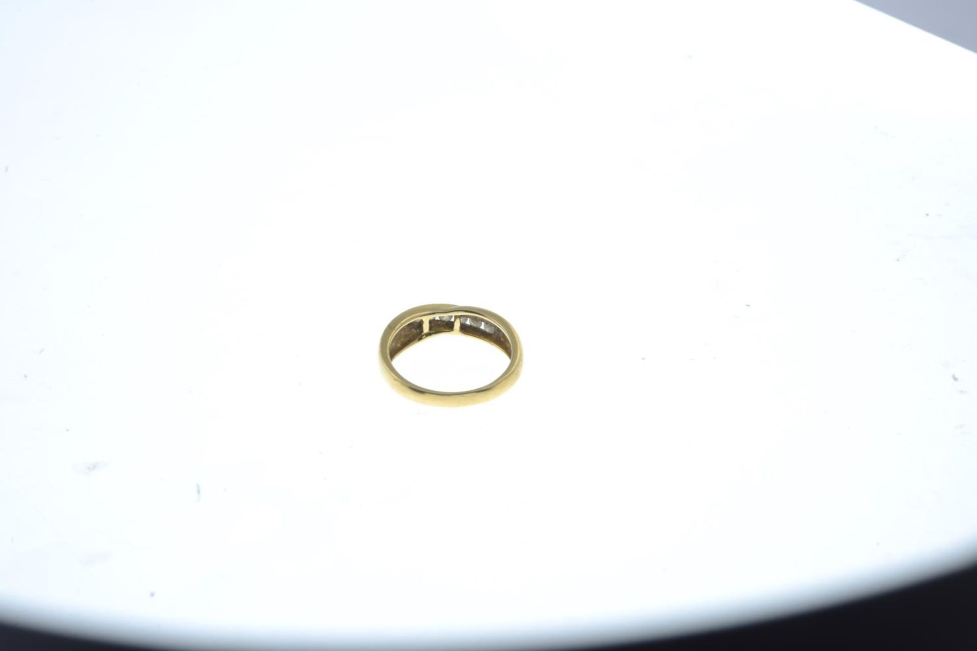 An 18ct gold brilliant-cut diamond crossover ring.Total diamond weight 0.25ct, stamped to band. - Image 2 of 3