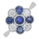 An 18ct gold sapphire and brilliant-cut diamond cluster ring.Sapphire weight 0.84ct.Diamond weight