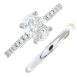 An oval-shape fracture-filled diamond single-stone ring and a polished band ring.Principal diamond