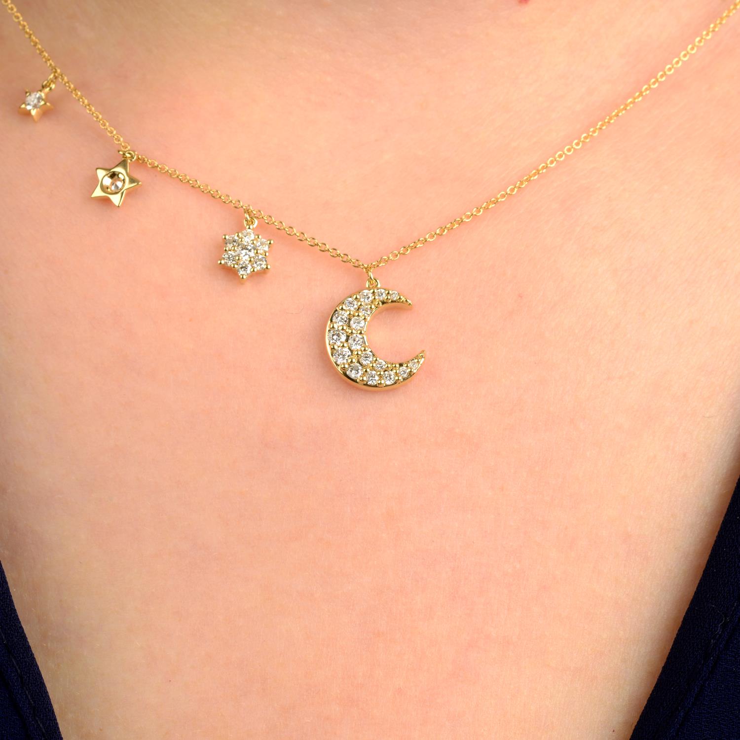 An 18ct gold diamond moon and stars necklace.Estimated total diamond weight 0.25ct,