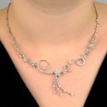 An 18ct gold vari-cut diamond floral spray necklace.Estimated total diamond weight 4 to 4.50cts,
