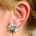 A pair of 18ct gold brilliant-cut diamond textured star earrings.