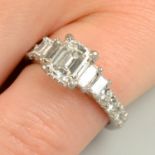 A rectangular-shape diamond single-stone ring, with brilliant and baguette-cut diamond sides.