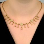 An Edwardian 15ct gold seed and split pearl floral necklace.Length 40cms.
