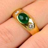 An emerald cabochon and brilliant-cut diamond three-stone band ring.