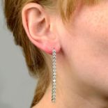 A pair of 18ct gold brilliant-cut diamond line drop earrings.