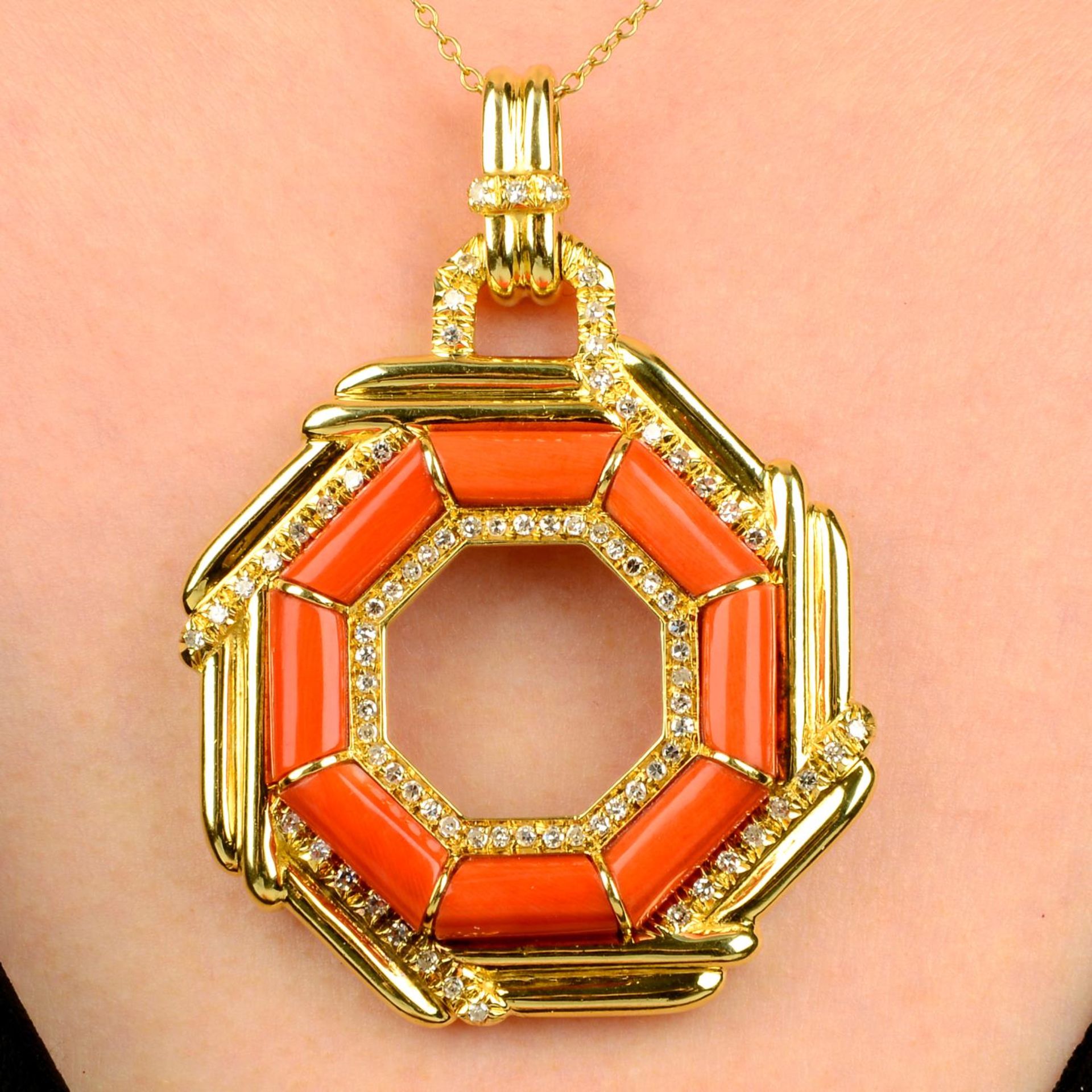 A coral and diamond pendant.
