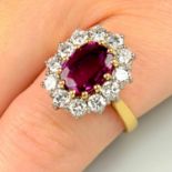 An 18ct gold ruby and brilliant-cut diamond cluster ring.Ruby calculated weight 1.19cts,