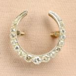 A diamond crescent brooch.