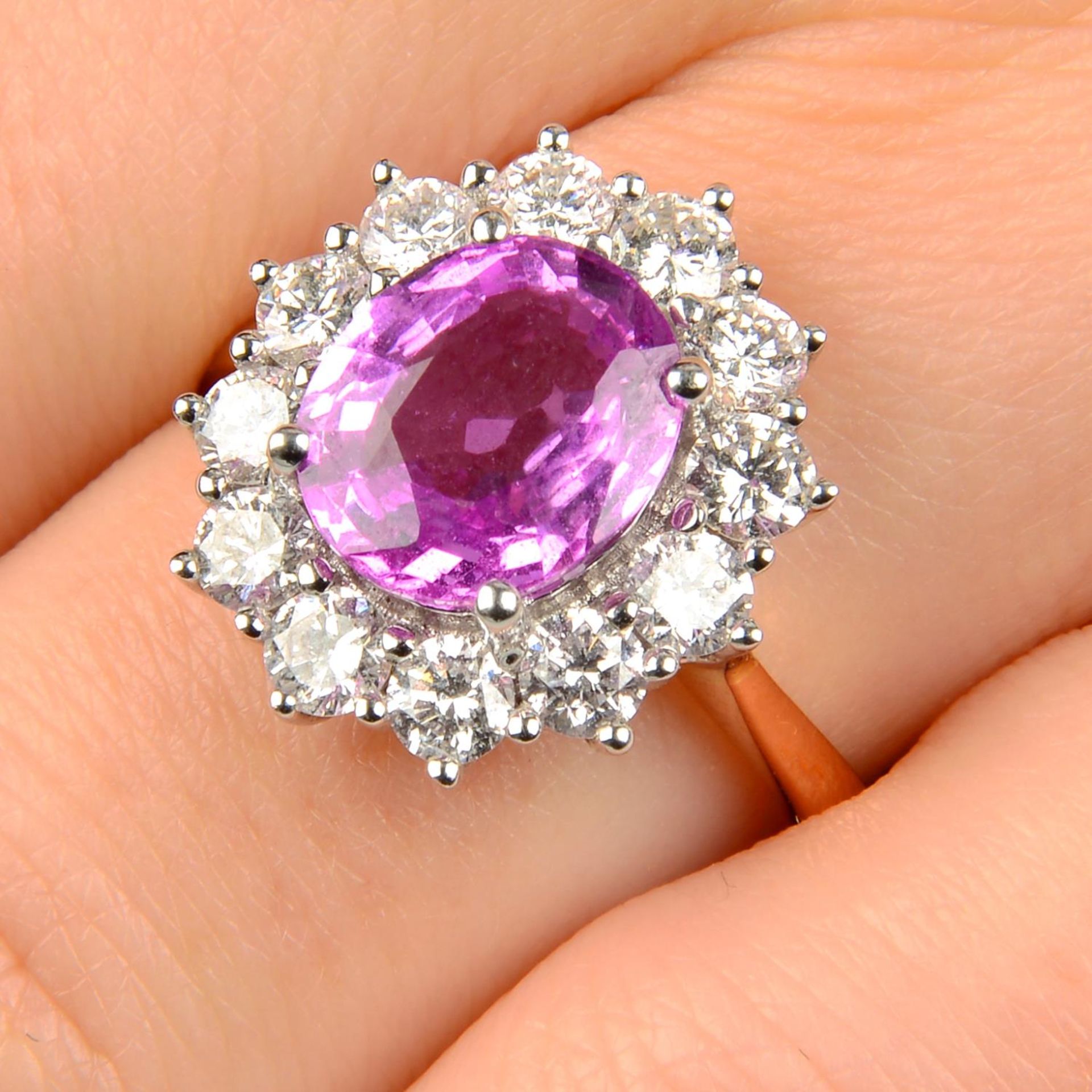 An 18ct gold pink sapphire and brilliant-cut diamond cluster ring.