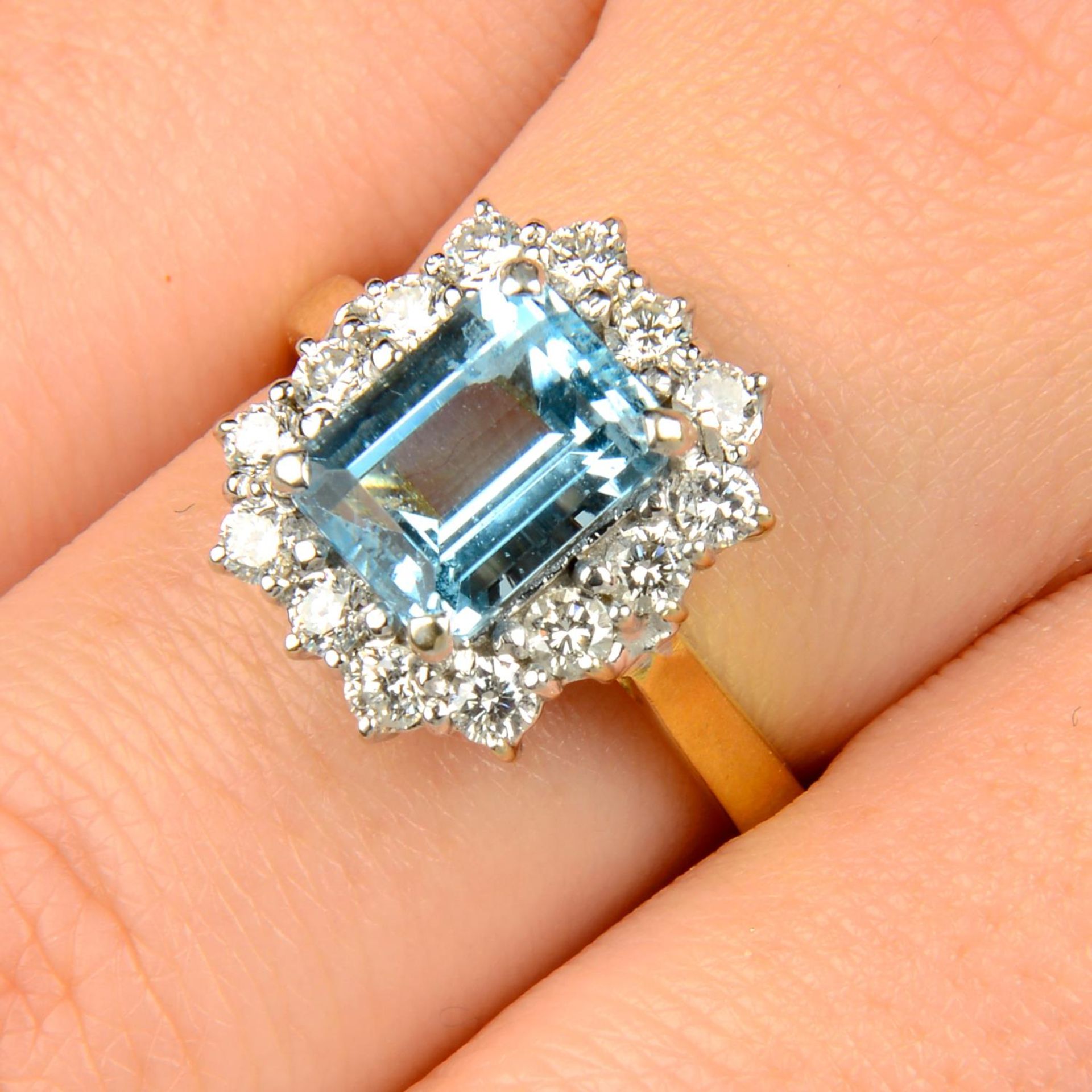 An aquamarine and brilliant-cut diamond cluster ring.Aquamarine calculated weight 2.22cts,