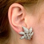 A pair of 18ct gold diamond floral earrings.