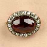 An early to mid 19th century silver and gold, garnet and old-cut diamond cluster brooch.